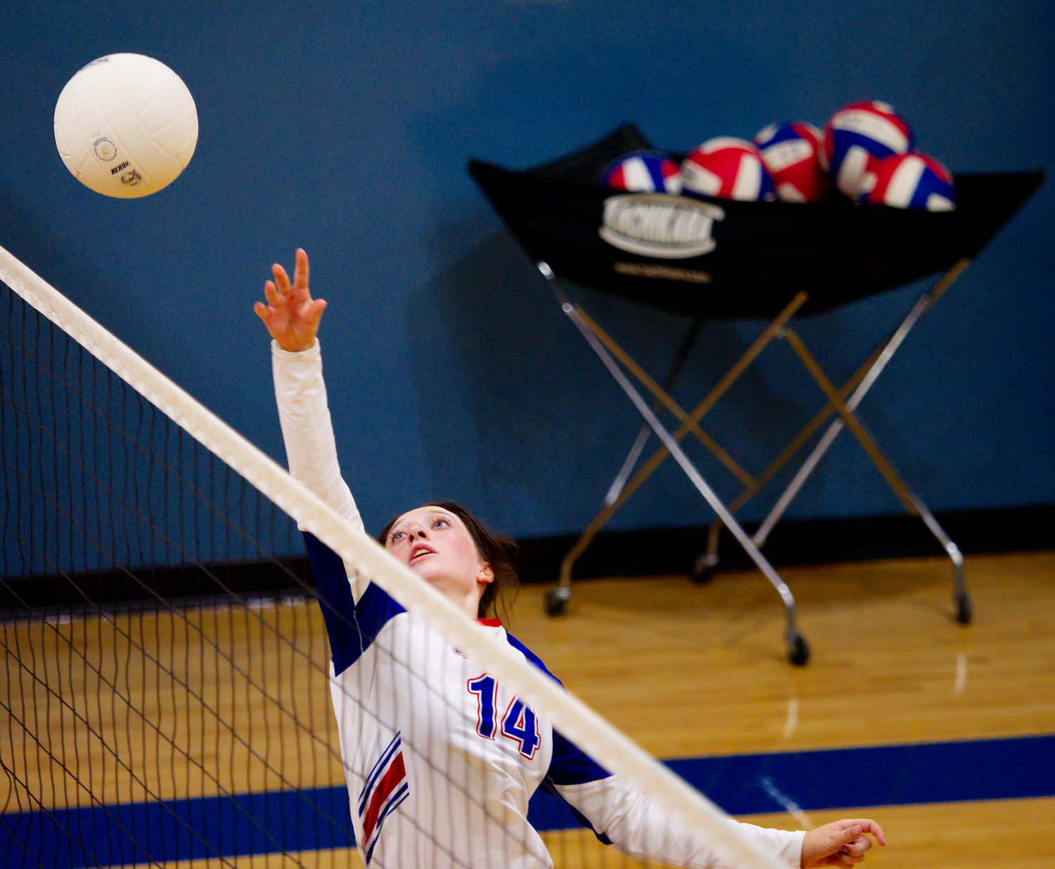 Peyton Kruckner tips the ball back for Quitman. [view more volleyball shots]